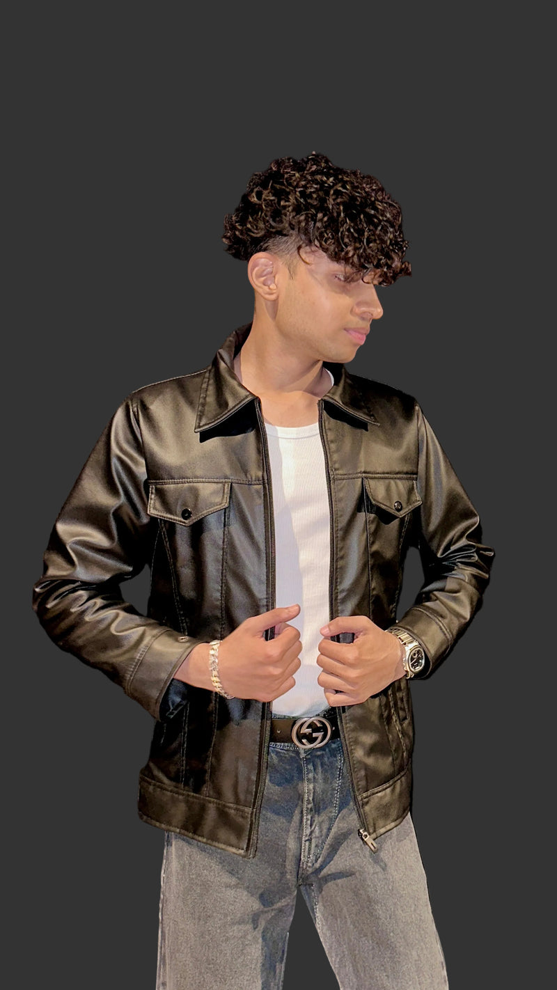 Person wearing a brown leather jacket and gray pants against a black background